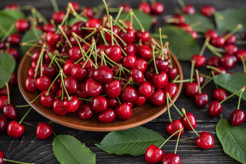 Tasty juicy sweet cherry on a wooden background. It can be used as a background