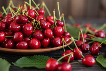 Tasty juicy sweet cherry on a wooden background. It can be used as a background