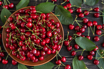 Tasty juicy sweet cherry on a wooden background. It can be used as a background