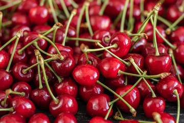 Tasty juicy sweet cherry on a wooden background. It can be used as a background
