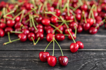Tasty juicy sweet cherry on a wooden background. It can be used as a background