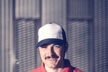 portrait of young man with cap and mustache