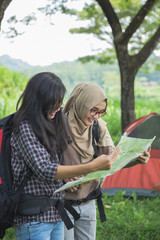 Fototapeta na wymiar friends hiking in outdoor summer activity using map