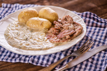 green pumpkin sauce with dill, new potatoes and pork medalions
