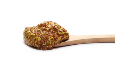 French mustard spreading with wooden spoon, isolated on white background and texture