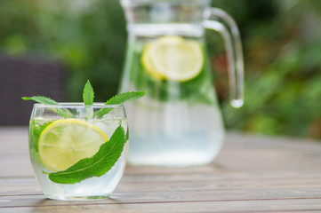 Fototapeta premium Fresh homemade lemonade with ice and mint on the table.