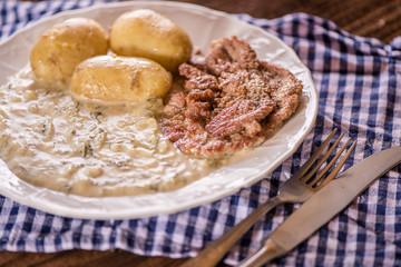 green pumpkin sauce with dill, new potatoes and pork medalions