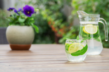 Fresh homemade lemonade with ice and mint on the table.