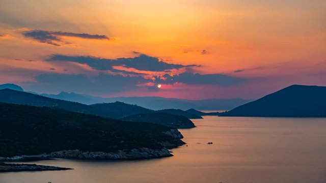 Panoramic view of sunset on small island Poros, Greece - Timelapse of summer sunset