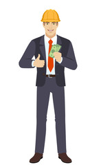 Businessman in construction helmet showing thumb up with cash money