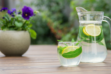 Fototapeta premium Fresh homemade lemonade with ice and mint on the table.