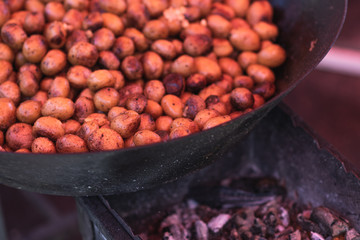 Potatoes are prerpaping in the wok on the food festival. street food business