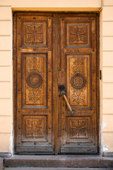 Brown vintage wooden door with elegant carving