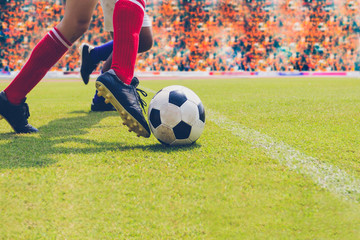 soccer or football player standing with ball on the field for Kick the soccer ball at football stadium,Soft focus