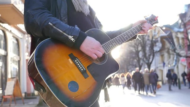 SOPOT POLAND touristic street musician busker man play acoustic guitar for money in public place
