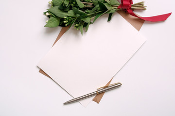 Kraft paper envelope with white card.