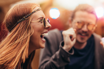Hippie girl enjoying with friends at music festival