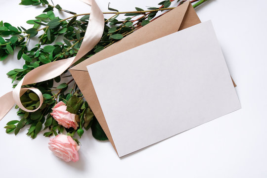 Mockup with postcard, flowers bouquet, kraft envelope.
