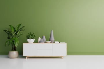 Modern interior of living room with cabinet and plants have green wall. 3d rendering