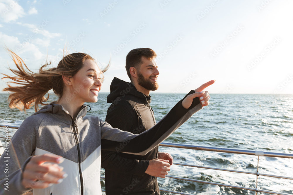 Canvas Prints Happy young sports couple jogging together at the beach