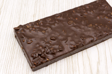 tile of black chocolate with hazelnuts .