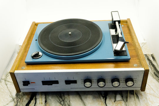 Vintage record player with radio tuner isolated on white background .