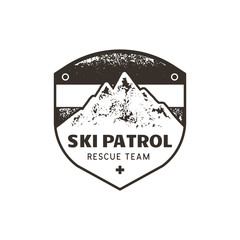 Vintage hand drawn mountain ski patrol emblem. Rescue team patch. Mountains stamp. Monochrome, grunge letterpress effect. Stock retro badge illustration isolated on white background