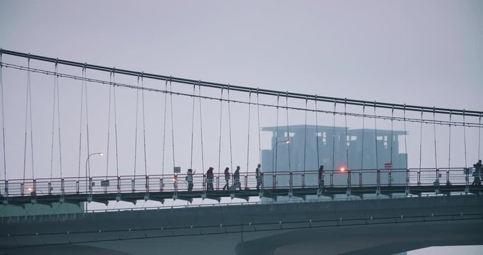 Tourist watching sunset at Bitan Scenic Area on Xindian River in Taipei, Taiwan