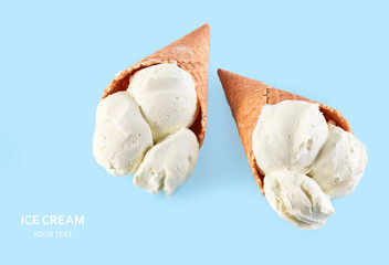 ice cream balls in a Waffle Cone on a Blue Background. Vanilla ice cream in a waffle cone.