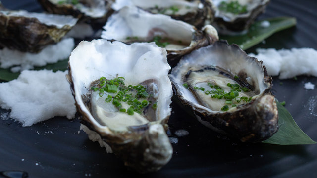 Canapes: fresh oysters topped with spring onion and rock salt