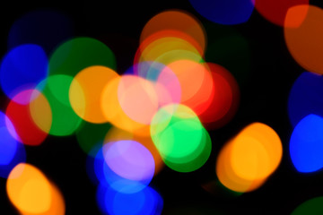 Blurred colorful circular facular on dark background.