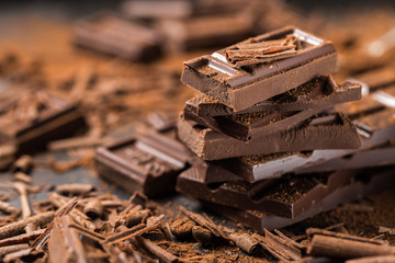 Pile of broken dark chocolate on table