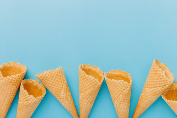 Empty waffle cones on blue background