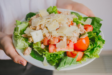 Girl holding healthy salad ready to eat