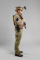 Special forces soldier with rifle on white background.