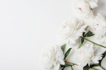 Obraz na płótnie Canvas Beautiful white peony flowers bouquet on pastel table top. Flat lay style.