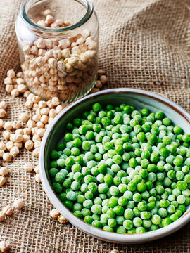 Still life with bowl of peas and jar of chickpeas