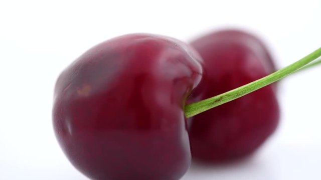 Cherry. Organic ripe cherries rotated closeup over white background. Rotation 4K UHD video 3840X2160