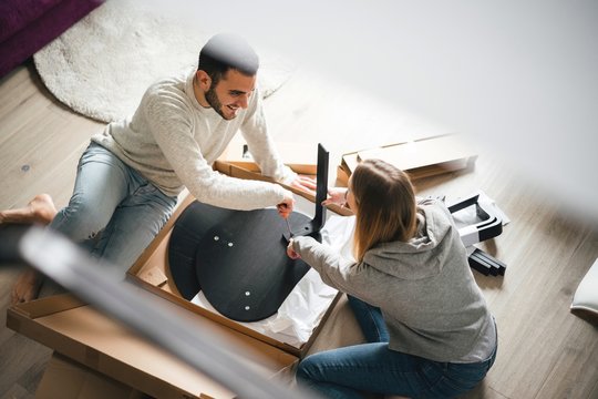 Couple assembling flat pack furniture
