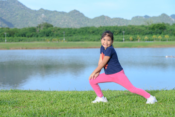 cute girl exercise on green grass