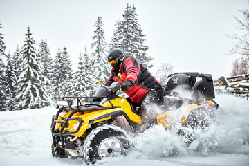 Winter race on an ATV on snow in the forest.