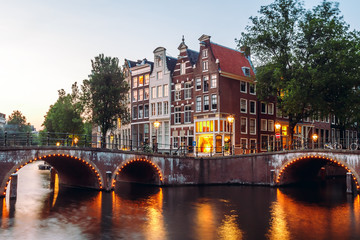 Naklejka premium Evening building on the streets and amsterdam channels with illumination