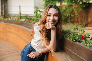 Smiling young girl in casual clothes looking at camera