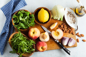 fresh ripe ingredients on a cutting wooden board on the table for summer salad recipes. healthy cuisine