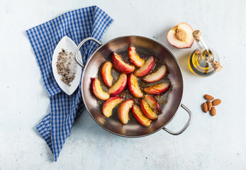 fried pieces of peaches in a frying pan on the table. Cooking.