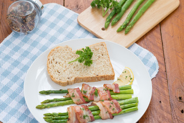 Fresh Young Asparagus Wrapped in Prosciutto Meat and Grilled on pan

