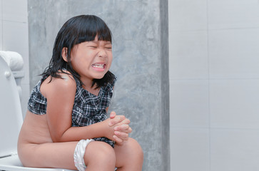 girl suffer stomach and sit in toilet
