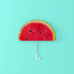 Watermelon umbrella on pastel blue background. Creative idea. minimal concept