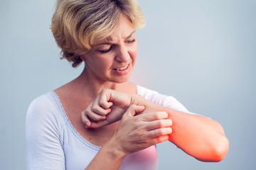Woman Scratching an itch on white background . Sensitive Skin, Food allergy symptoms, Irritation