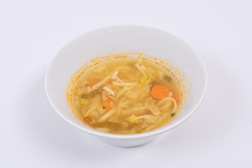 Noodle soup with vegetables on a white